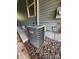 Side exterior of the home with visible AC unit and gravel providing necessary ventilation at 402 California St, York, SC 29745