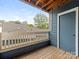 Charming balcony with a wooden floor and wood railing with views of trees and other rooftops at 415 Mather Green Ave # I, Charlotte, NC 28203