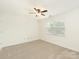 Bright bedroom with neutral carpet, a ceiling fan, and a large window at 415 Mather Green Ave # I, Charlotte, NC 28203