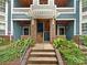 Inviting condo entrance with brick accents, covered walkways, and well-maintained landscaping at 415 Mather Green Ave # I, Charlotte, NC 28203