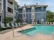 Exterior view of the apartment complex's common pool area with lounge chairs at 415 Mather Green Ave # I, Charlotte, NC 28203