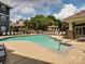 Community pool with lounge chairs and manicured landscaping under sunny sky at 415 Mather Green Ave # I, Charlotte, NC 28203