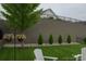 Secluded backyard with retaining wall and young trees offers a private, well-manicured outdoor space at 4831 Looking Glass Trl, Denver, NC 28037