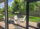 Landscaped backyard featuring a stone patio with a fire pit and adirondack chairs at 4831 Looking Glass Trl, Denver, NC 28037