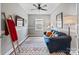 Comfortable bedroom with a blue sofa, colorful rug, TV, and window at 4831 Looking Glass Trl, Denver, NC 28037