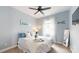 Serene bedroom with soft blue walls, white accents, and natural light creating a relaxing space at 4831 Looking Glass Trl, Denver, NC 28037