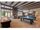 Bright community room features billiard tables, shuffle board, multiple lounging areas, and abundant natural light at 4831 Looking Glass Trl, Denver, NC 28037