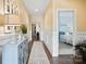 Elegant hallway featuring beautiful hardwood floors, wainscoting, and a view to the bedroom at 4831 Looking Glass Trl, Denver, NC 28037