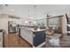 Open concept kitchen with granite counters, stainless appliances, and view into the living room at 4831 Looking Glass Trl, Denver, NC 28037