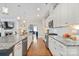 Spacious kitchen with white cabinets, stainless steel appliances, hardwood floors and granite countertops at 4831 Looking Glass Trl, Denver, NC 28037