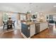 Kitchen island flows into the living room, featuring granite countertops and stainless steel appliances at 4831 Looking Glass Trl, Denver, NC 28037