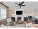 Cozy living room with fireplace, plush seating, ceiling fan, and stylish décor at 4831 Looking Glass Trl, Denver, NC 28037