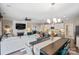 Open-concept living room and kitchen with fireplace, dining area, and modern fixtures at 4831 Looking Glass Trl, Denver, NC 28037