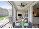 Inviting screened-in patio with ceiling fan, grill, and patio dining furniture for outdoor living at 4831 Looking Glass Trl, Denver, NC 28037