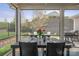Screened patio features a table set for four, beautiful backyard views, and room for entertaining at 4831 Looking Glass Trl, Denver, NC 28037