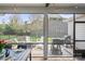 Screened patio features a seating area, grill, and beautiful backyard with a stone wall at 4831 Looking Glass Trl, Denver, NC 28037