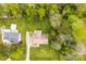 Aerial view of a home with a pool, surrounded by lush green trees and a well-manicured lawn at 504 Ogden Dr, Gastonia, NC 28056