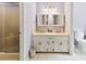 Bathroom featuring a double vanity, neutral tile flooring, and a separate shower stall at 504 Ogden Dr, Gastonia, NC 28056