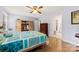 Serene bedroom with natural light, wood-look floors, and a cozy quilt on the bed at 504 Ogden Dr, Gastonia, NC 28056