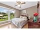 Cozy bedroom with a large window, ceiling fan, and light wood-look flooring at 504 Ogden Dr, Gastonia, NC 28056
