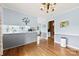 Well-lit dining area with hardwood floors, view into kitchen, and classic decor, ideal for Gathering meals at 504 Ogden Dr, Gastonia, NC 28056