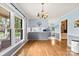 Bright dining room with hardwood floors and large windows, open to the kitchen area at 504 Ogden Dr, Gastonia, NC 28056