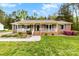 Charming brick ranch home with covered porch, green shutters, landscaping, and a well-maintained front yard at 504 Ogden Dr, Gastonia, NC 28056