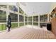 Bright and airy screened porch with high ceilings, paneled wood floors, and views of the backyard at 504 Ogden Dr, Gastonia, NC 28056
