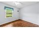 Bedroom featuring hardwood floors and a bright window with exterior views at 5211 Driftwood Dr, Davidson, NC 28036
