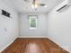 Comfortable bedroom with wood floors, ceiling fan and neutral decor at 5211 Driftwood Dr, Davidson, NC 28036