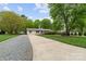 Inviting single-story home featuring a long drive, well-manicured lawn, and mature trees at 5211 Driftwood Dr, Davidson, NC 28036