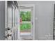 Front entry showing a storm door with a view to the front yard at 5211 Driftwood Dr, Davidson, NC 28036