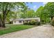 Manicured front yard features mature trees and shrubs adding to the home's curb appeal at 5211 Driftwood Dr, Davidson, NC 28036