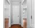 Hallway with wood floors, white trim, and doors leading to various rooms at 5211 Driftwood Dr, Davidson, NC 28036