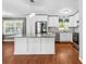 Well-appointed kitchen with a large island, stainless appliances, and hardwood floors at 5211 Driftwood Dr, Davidson, NC 28036