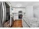 Updated kitchen featuring stainless steel appliances, granite counters and white cabinets at 5211 Driftwood Dr, Davidson, NC 28036