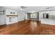 Bright living room with hardwood floors, brick fireplace, and modern finishes at 5211 Driftwood Dr, Davidson, NC 28036