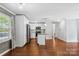 Open-concept living area with kitchen and island offers seamless flow and modern design at 5211 Driftwood Dr, Davidson, NC 28036