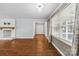 Inviting living room with wood floors, brick fireplace and large windows at 5211 Driftwood Dr, Davidson, NC 28036
