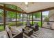 Cozy screened-in porch with outdoor seating and view of the landscaped backyard at 5211 Driftwood Dr, Davidson, NC 28036