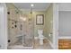 Recently renovated bathroom with tiled shower with bench, glass doors, updated toilet, and neutral paint at 528 1St Nw Ave, Hickory, NC 28601