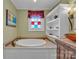 Bathroom with a large soaking tub and large cabinet with an eye-catching sink and bronze faucet at 528 1St Nw Ave, Hickory, NC 28601