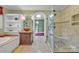 Bathroom with walk through shower and separate tub, cabinet and shelving with light green walls at 528 1St Nw Ave, Hickory, NC 28601