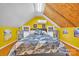 Bedroom with exposed wooden ceiling detail features an air conditioner and natural light from windows at 528 1St Nw Ave, Hickory, NC 28601