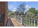 A wooden deck with white railings overlooks the lawn and surrounding neighborhood trees at 528 1St Nw Ave, Hickory, NC 28601
