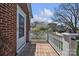 A wooden deck with white railings overlooks the lawn and surrounding neighborhood trees at 528 1St Nw Ave, Hickory, NC 28601
