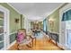 Charming dining room featuring green walls, beautiful trim, hardwood floors and natural light at 528 1St Nw Ave, Hickory, NC 28601
