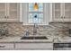 Close up on kitchen sink, granite counters, tile backsplash, and custom cabinets at 528 1St Nw Ave, Hickory, NC 28601