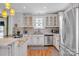 Bright kitchen with stainless steel appliances, tile backsplash, and hardwood floors at 528 1St Nw Ave, Hickory, NC 28601