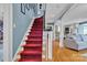 Elegant staircase with carpet runner, hardwood floors, and views into the adjoining rooms at 528 1St Nw Ave, Hickory, NC 28601